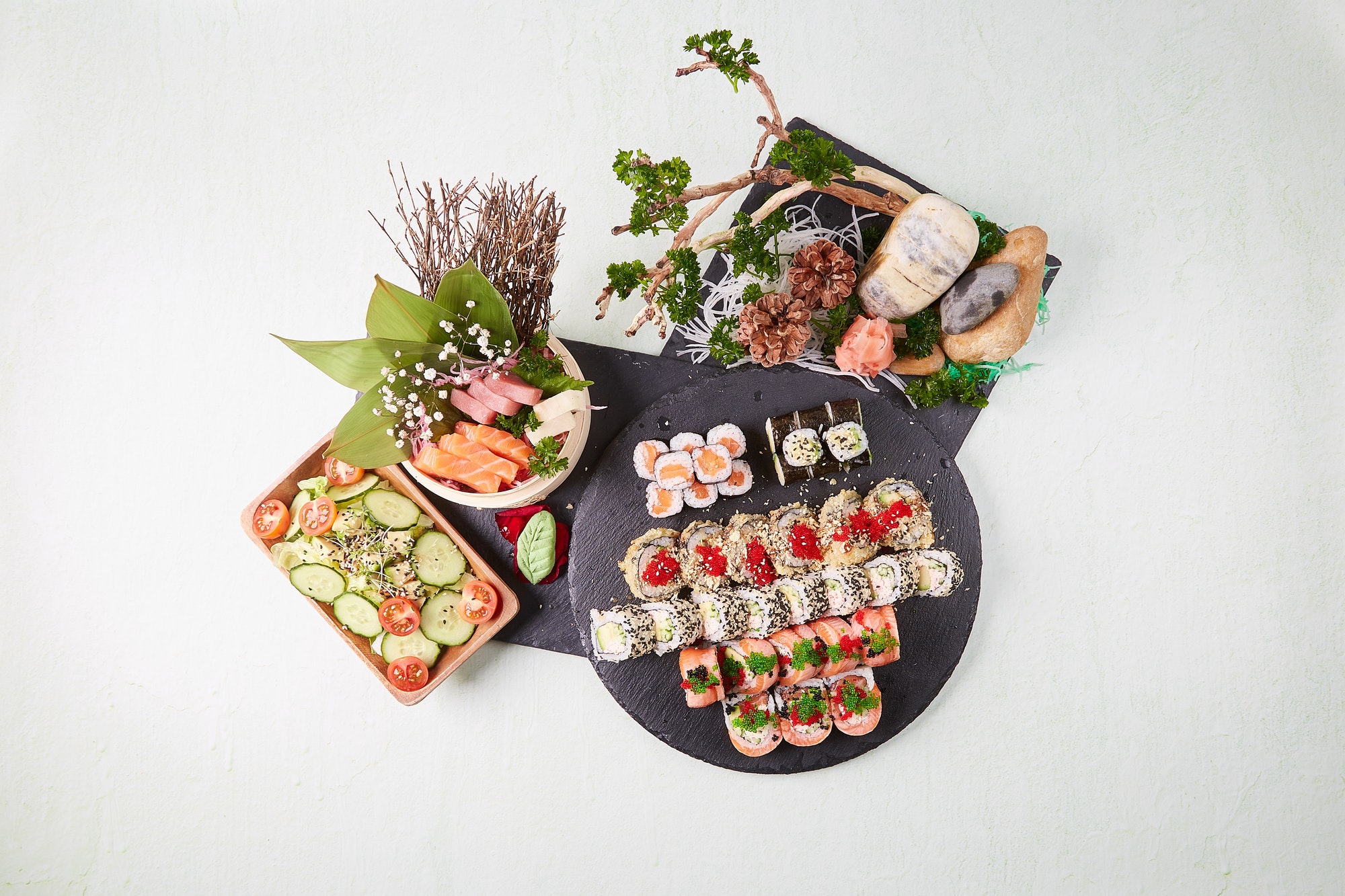 Flatlay photo of beautifully decorated Sushi meal.